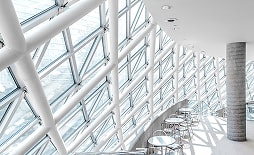 複雑な鉄骨フレームが張り巡らされた、明るい屋内施設の空間